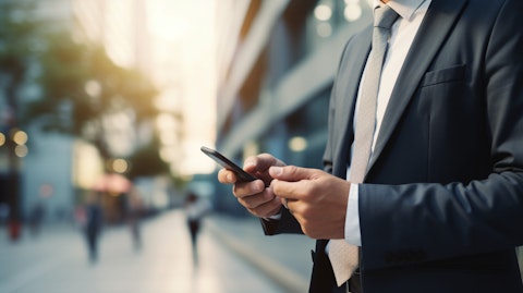 A successful business professional using a mobile device to access the company's innovative online B2B and B2C commerce solutions.