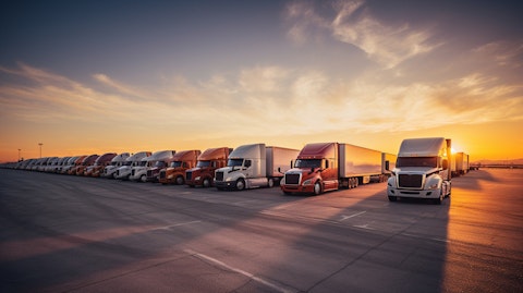 A fleet of freight trucks parked in sequence, showcasing the efficiency of the company's freight transportation.