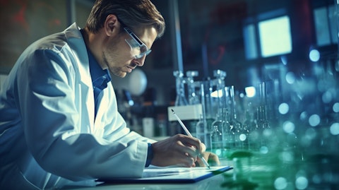 A scientist in a lab analyzing data from trials of a small molecule Abelson tyrosine kinase inhibitor.