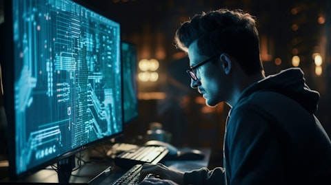 An engineer typing code in front of a computer screen to improve machine vision.