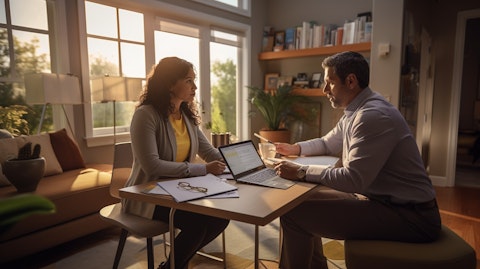 An insurance agent talking to a customer in their home office about healthcare insurance options.