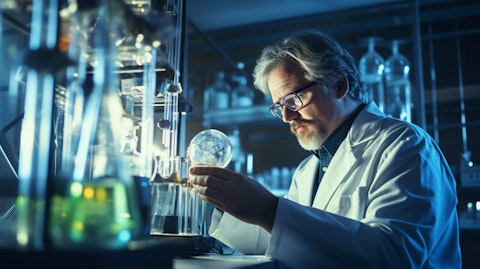 A laboratory scene, showing a scientist holding a beaker and examining its contents.