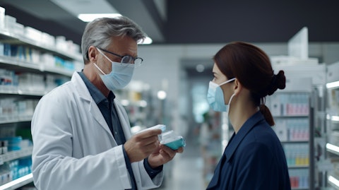 A pharmacist discussing with a patient wearing a face mask, examining their eye to diagnose a macular degeneration.