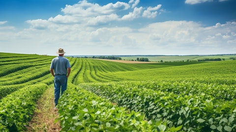 A farmer in a field, surveying the increased yields of a crop cultivated with agricultural technology.