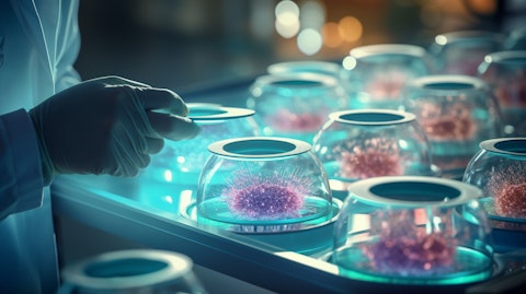 A scientist examining a petri dish filled with virus cultures.
