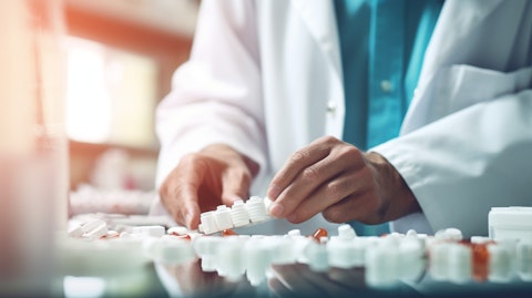 A pharmacist technician sorting pills in a drug pharmacy.