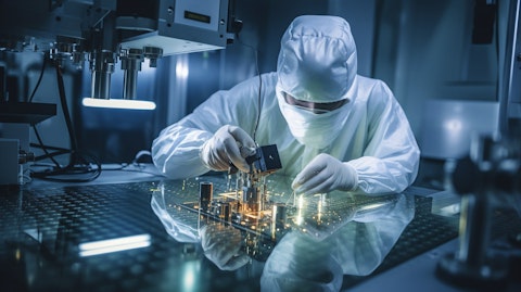 A technician in a lab coat working on a specialized multi-axis coating system.