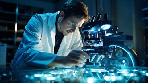 A scientist in a lab coat studying a petri dish through a microscope.