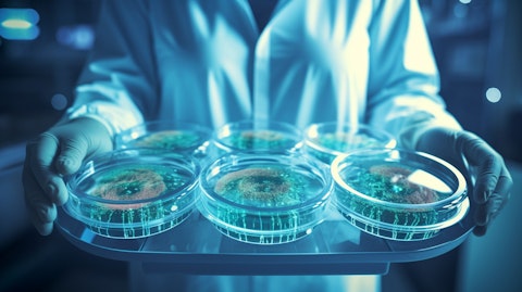 A laboratory technician examining a Petri dish filled with stem cells.