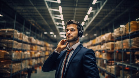 A manager wearing a headset in a warehouse, making decisions about asset management in real-time.
