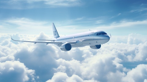 A large commercial aircraft soaring through the clouds, its window reflecting the clouds and the blue sky.