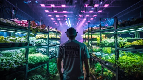 An engineer in front of an array of horticulture lighting equipment, examining the results.