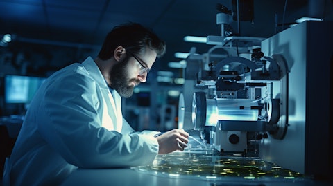 A technician in a lab coat operating a specialized machine to create optical switching films.