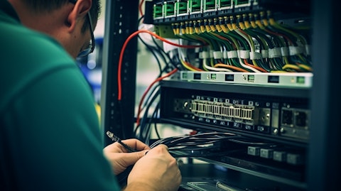 A technician connecting fiber optic cabling into a plug and play cassette module.
