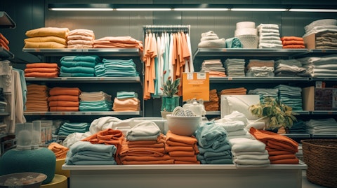 A store cubicle filled with textiles, clothing, bedding, and bath items.